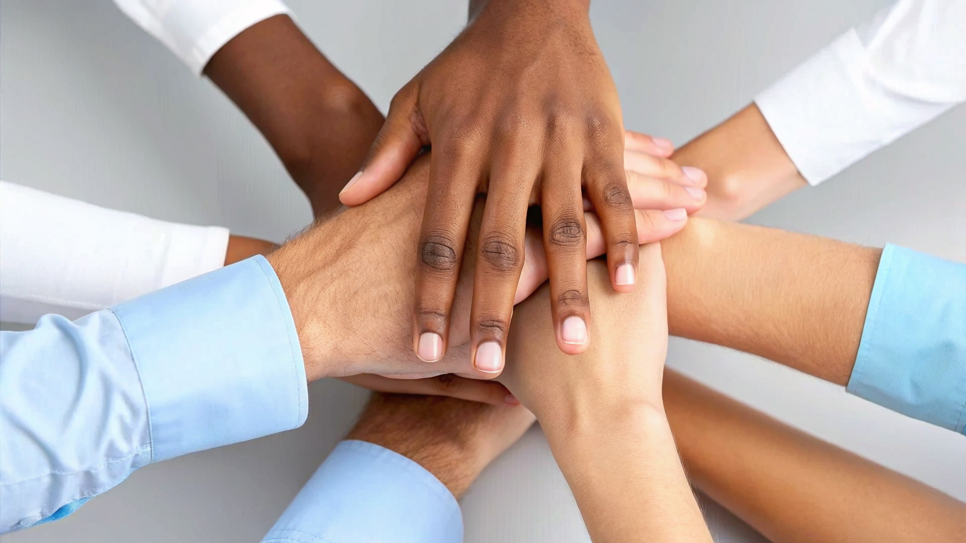 Hands on top of each other as a sign of unity.
